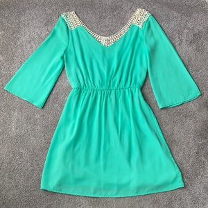 Mint green dress with cinched waist, bell sleeves, and beautiful tan knit back